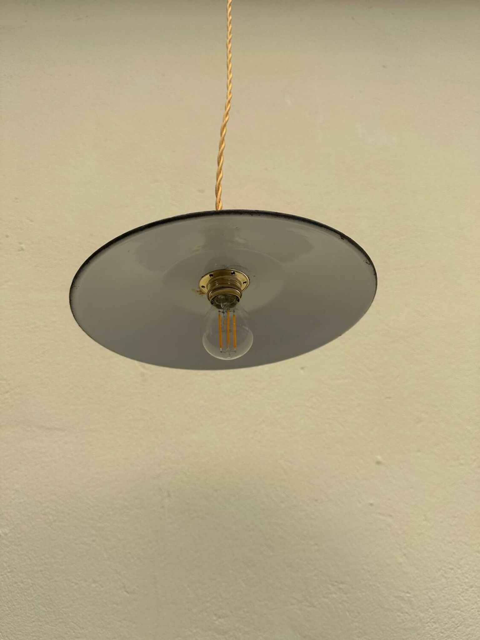 Old industrial black and white vintage enameled sheet metal pendant light