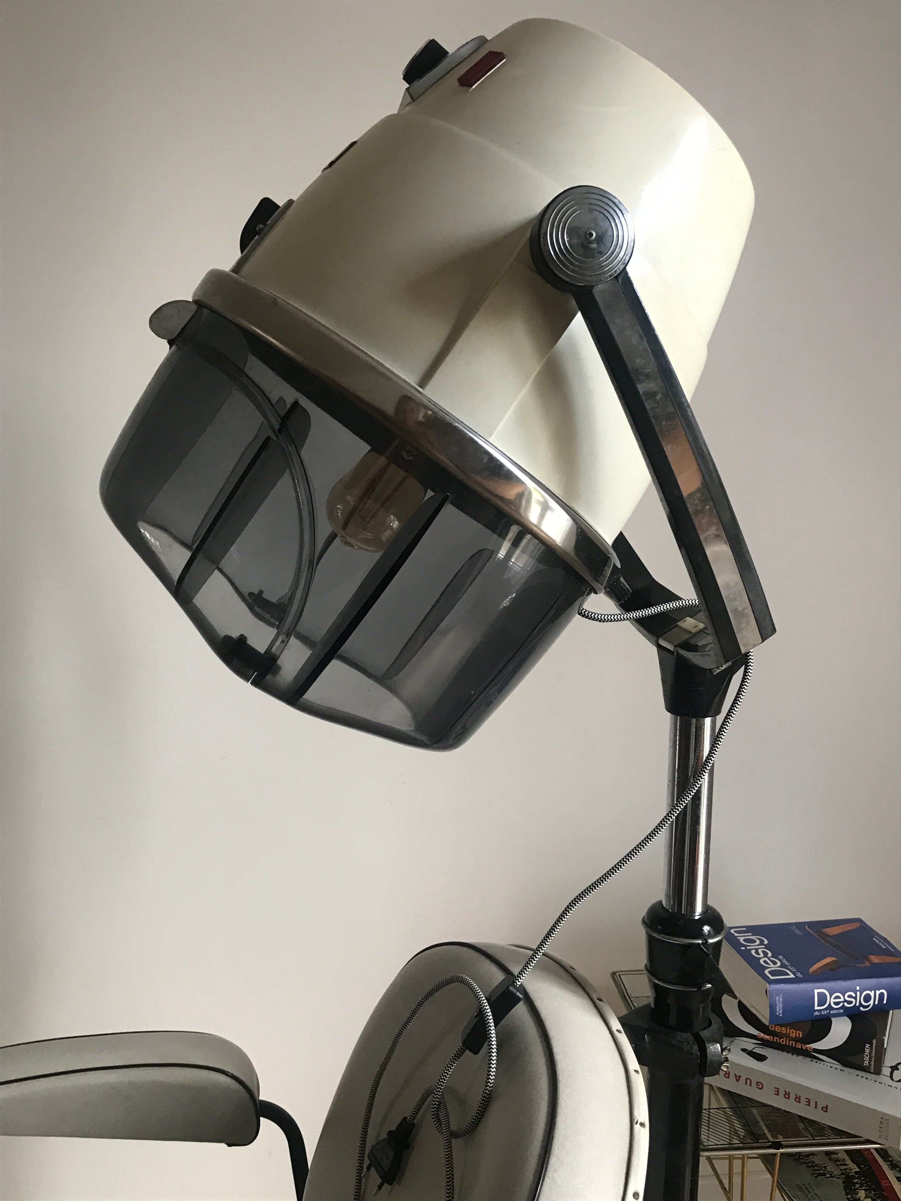 Vintage hairdresser's armchair with helmet transformed into a lamp