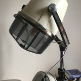 Vintage hairdresser's armchair with helmet transformed into a lamp