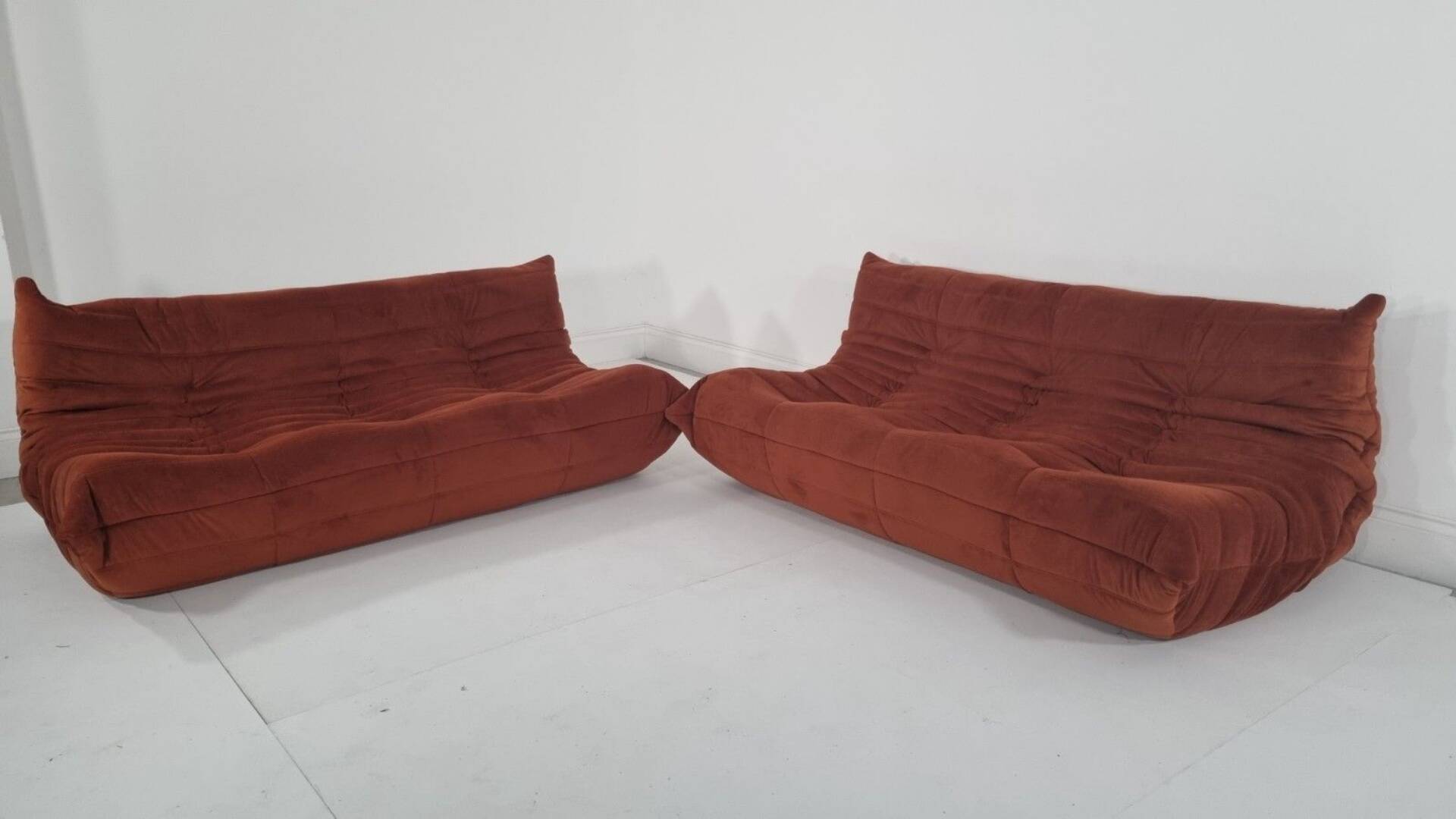 Ligne Roset Pair of 3-seater Togo sofas in rust velvet