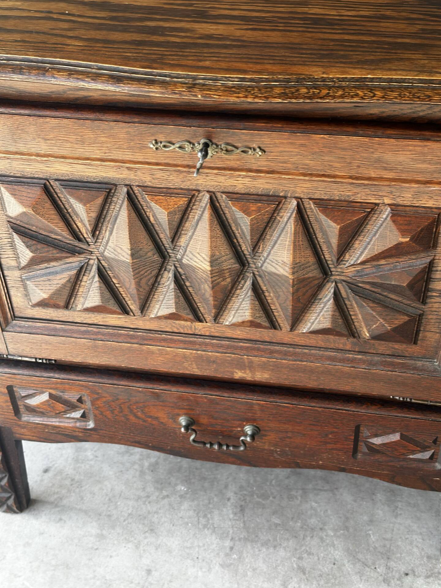Small storage cabinet in carved oak – circa 1930