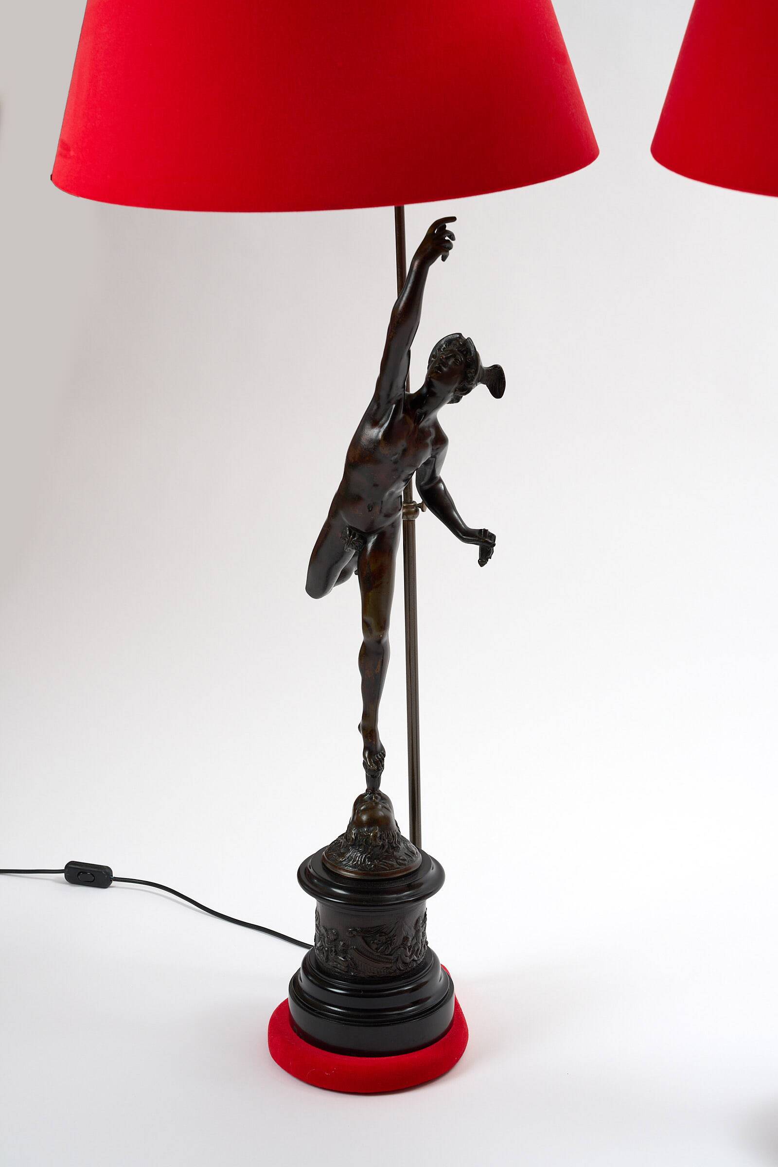 Pair of bronze lamps with red shades