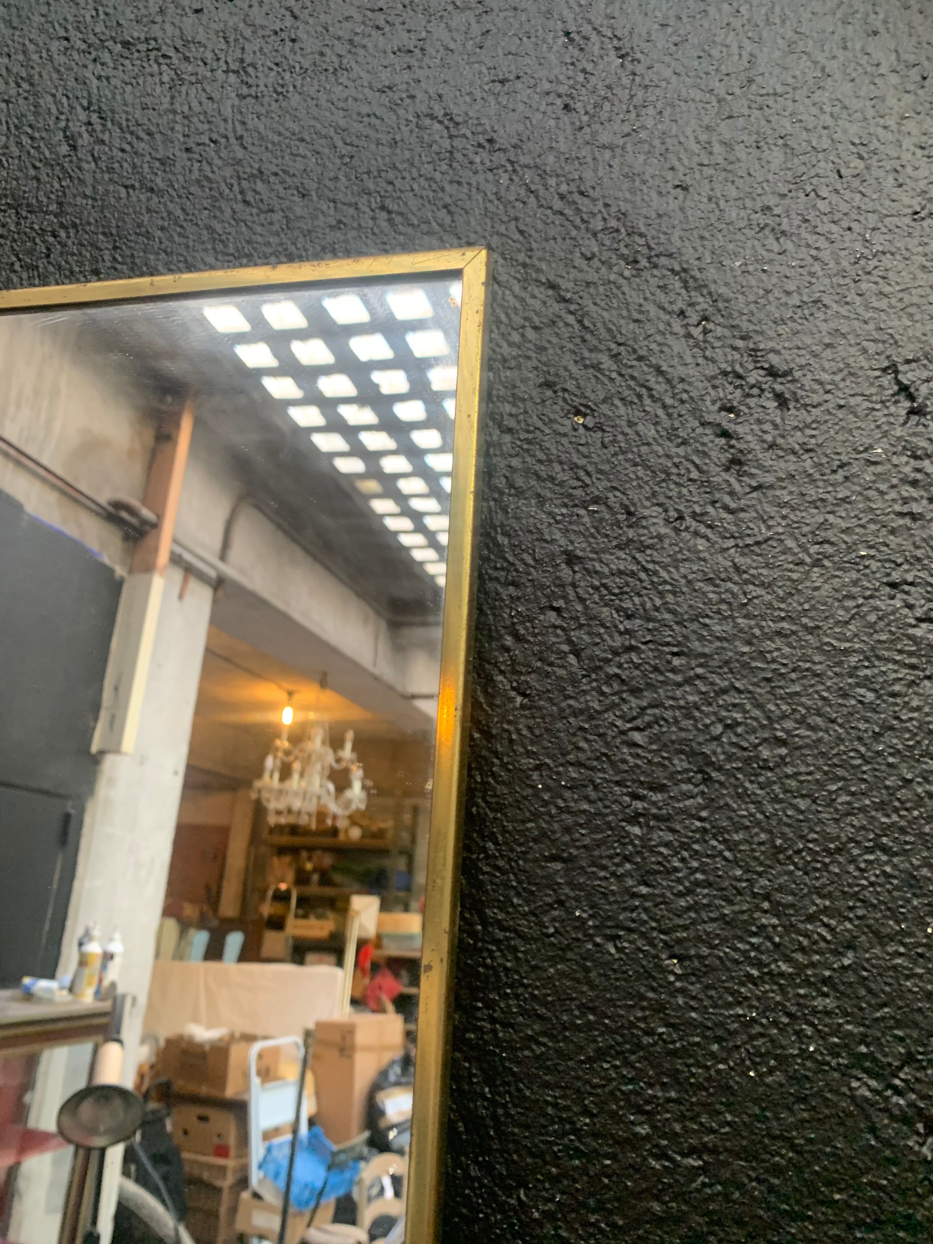 Mirror of two, narrow glass in gold metal 1950