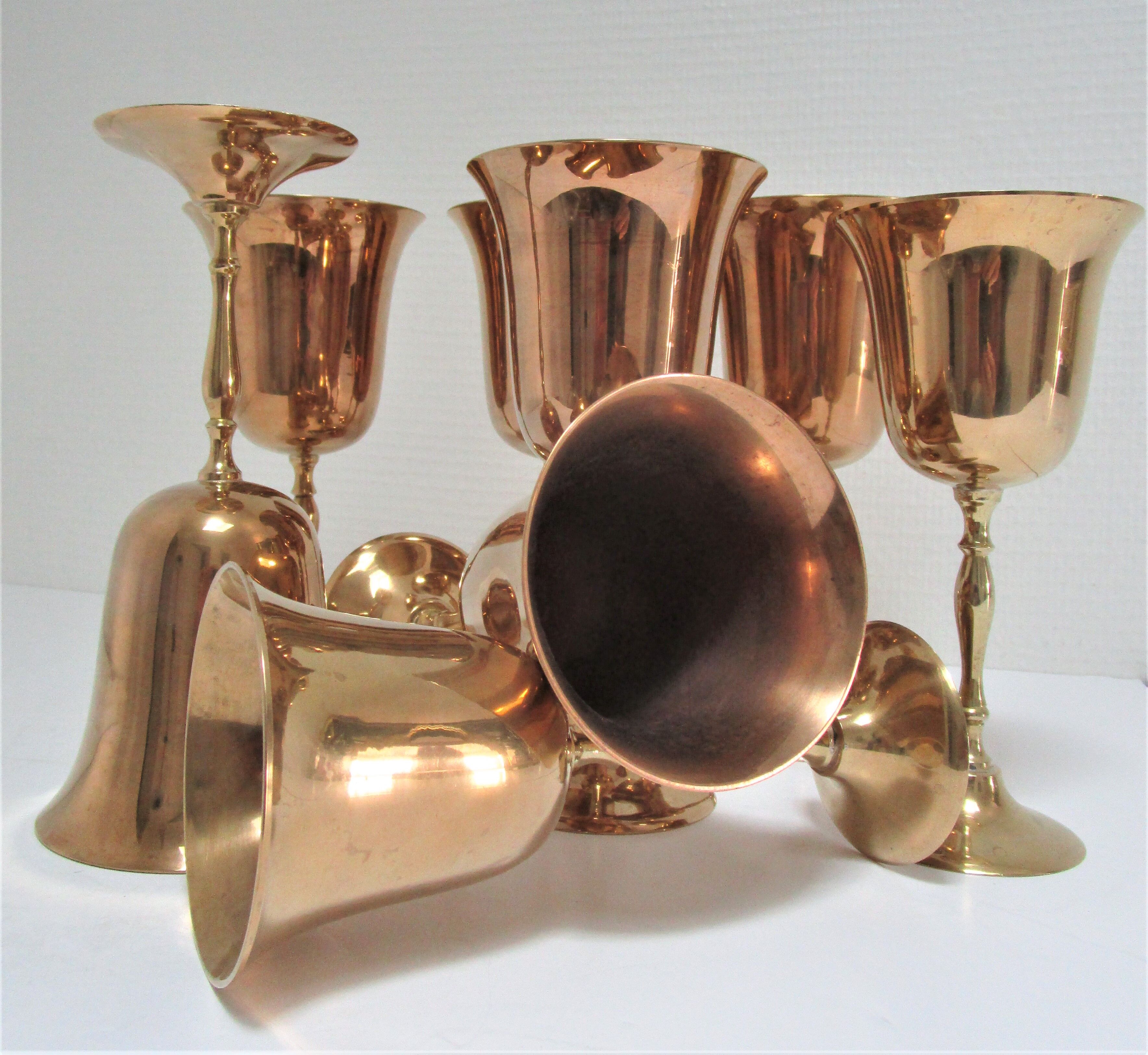 Set of eight vintage solid brass walking glasses