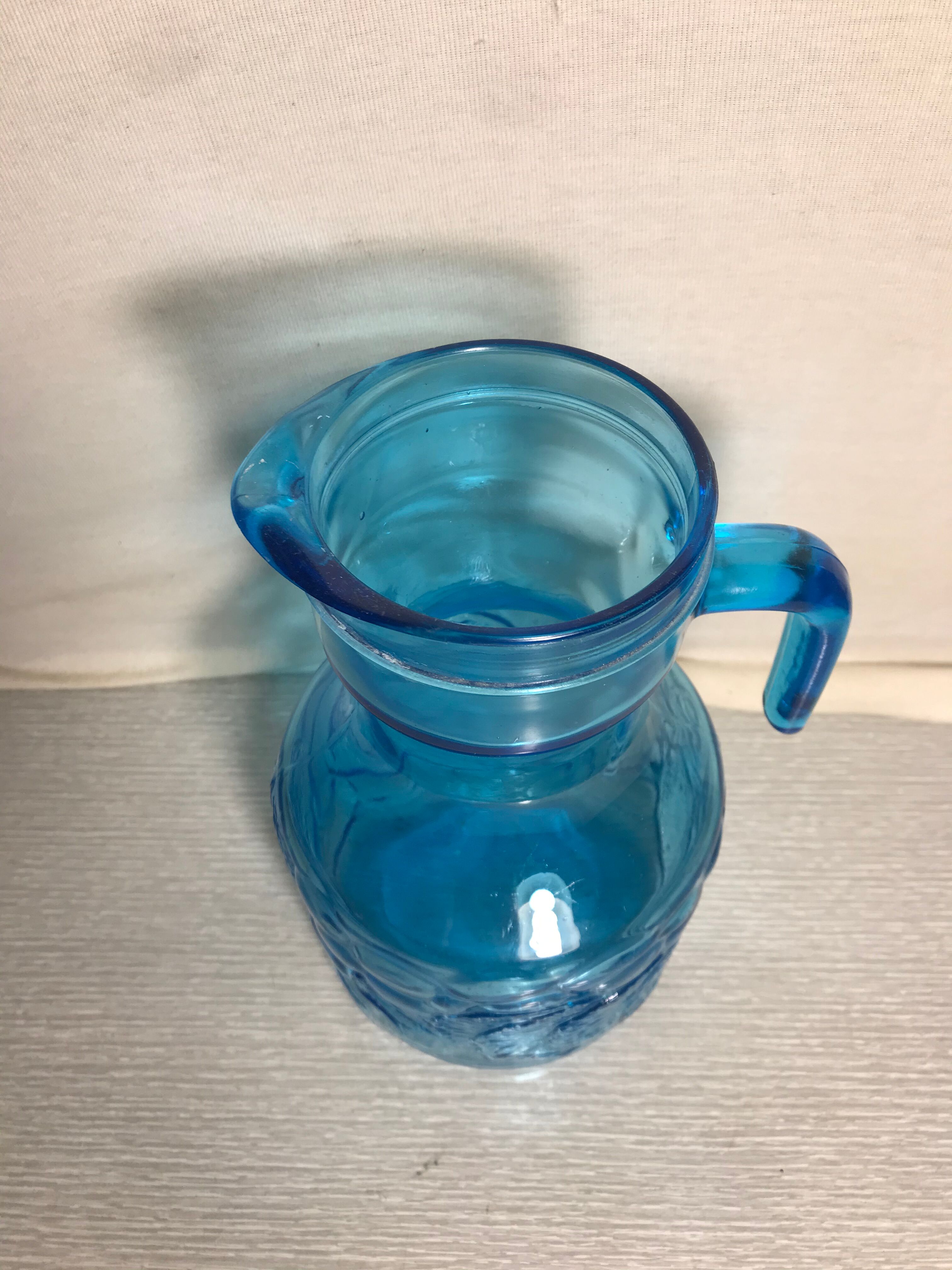 Blue moulded pitcher with decorative handle