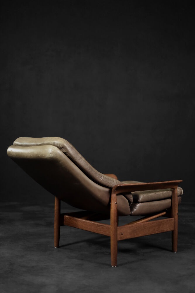 High teak and brown leather armchair with reclining backrest, mid-century Danish style, 1960s.