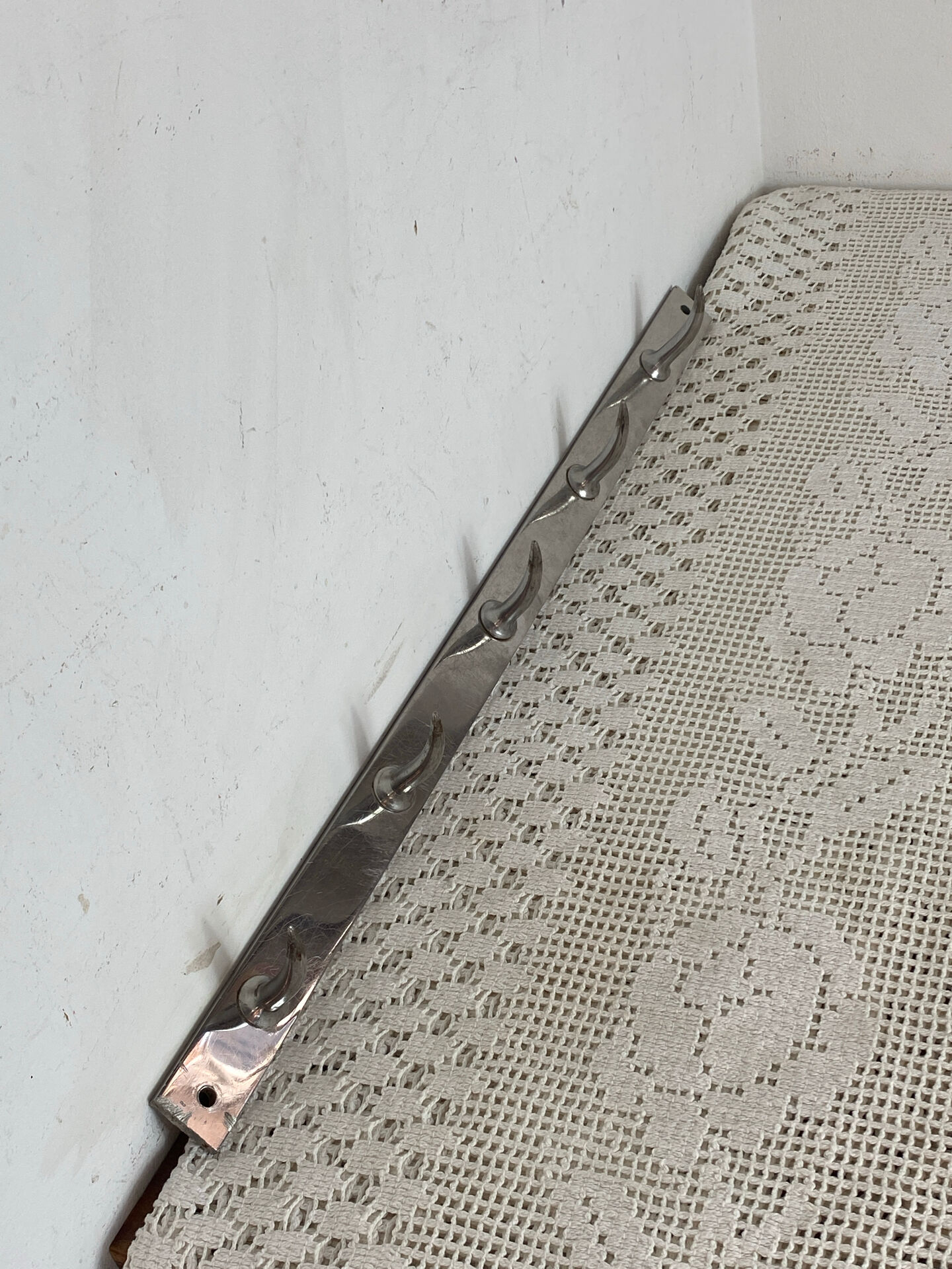 Stainless steel butcher's hook, known as a "wolf tooth bar."