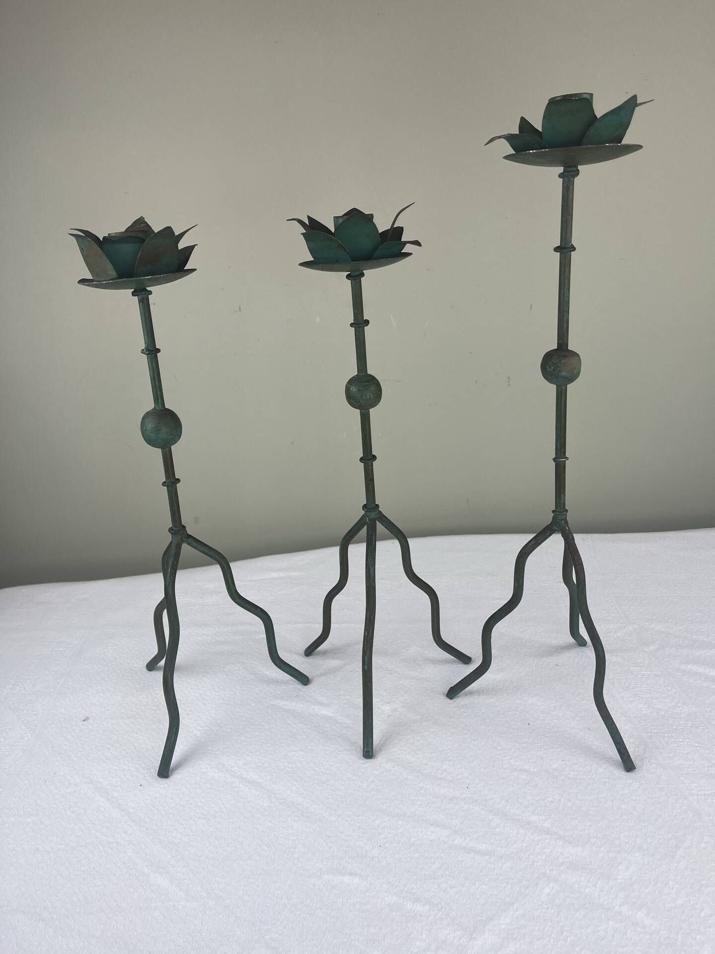 Sculptural candle holder trio