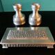Pair of white pewter candlesticks decorated with bas-relief. "Perletin". Norway 1960