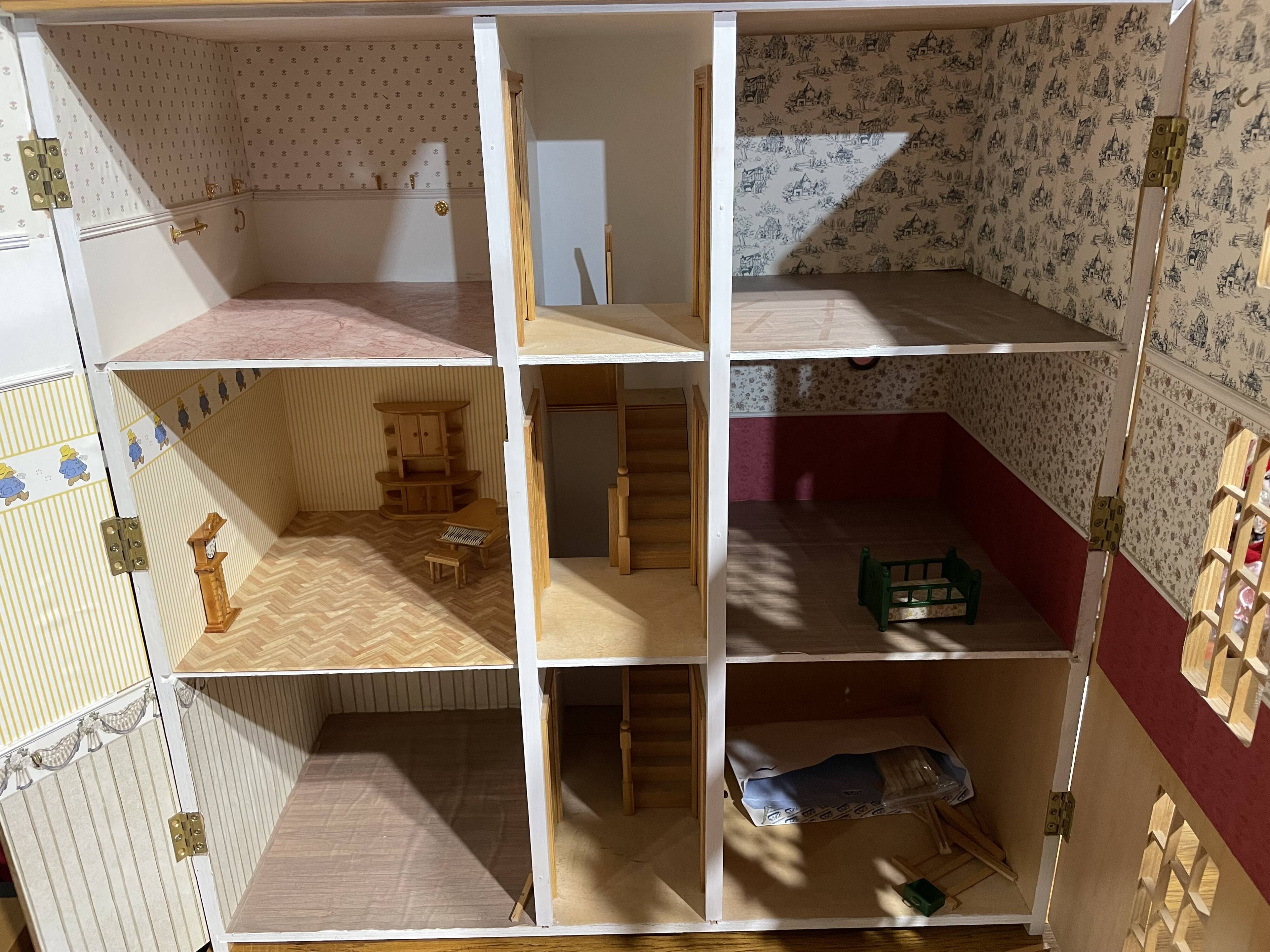 Large wooden dollhouse with miniature furniture