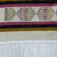 Handmade Berber kilim rug with multicoloured tribal motifs.