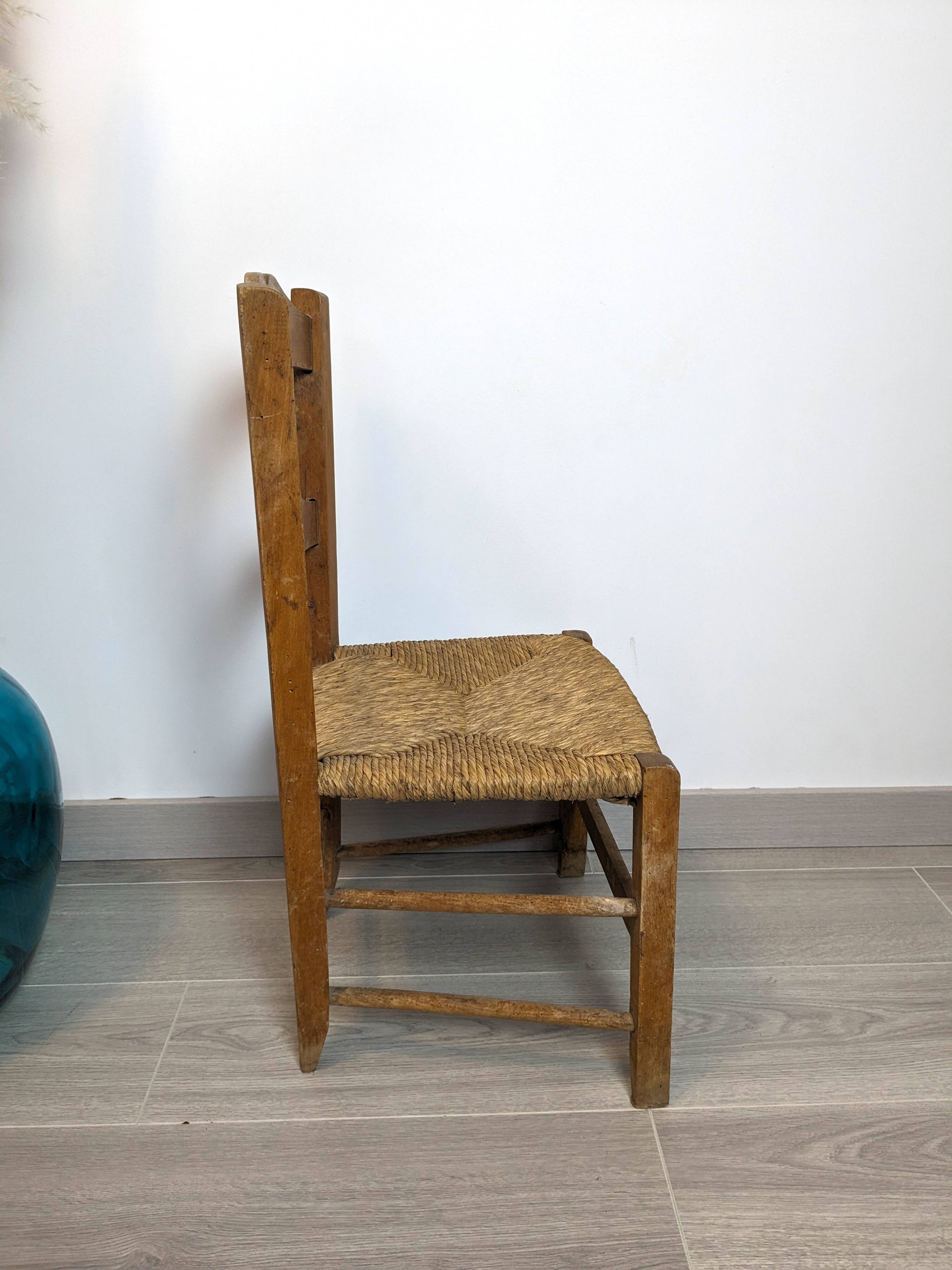 Vintage wooden and straw children's chair in a country style.