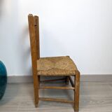 Vintage wooden and straw children's chair in a country style.