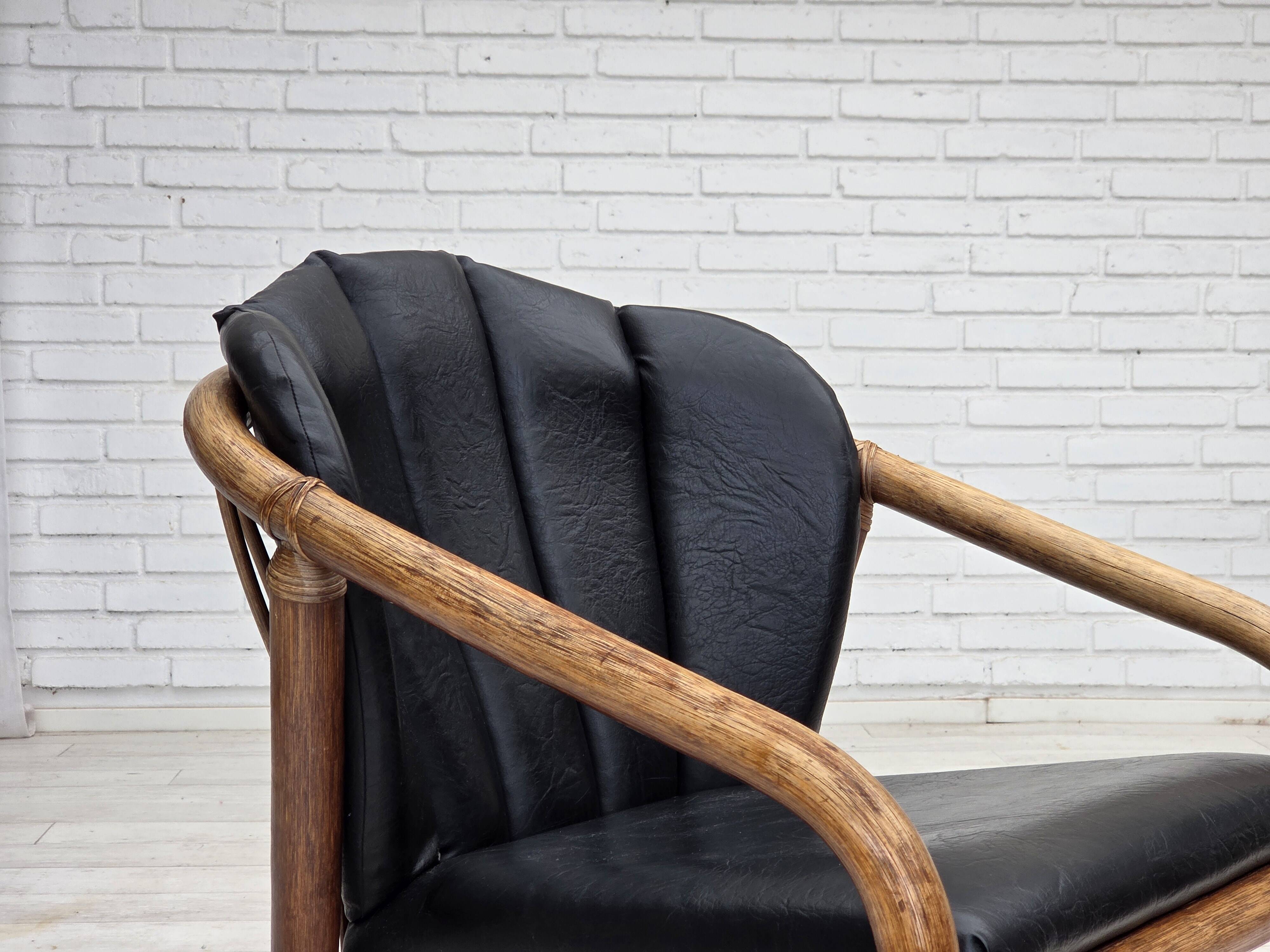 1970s, Danish armchair, rattan, black artificial leather.