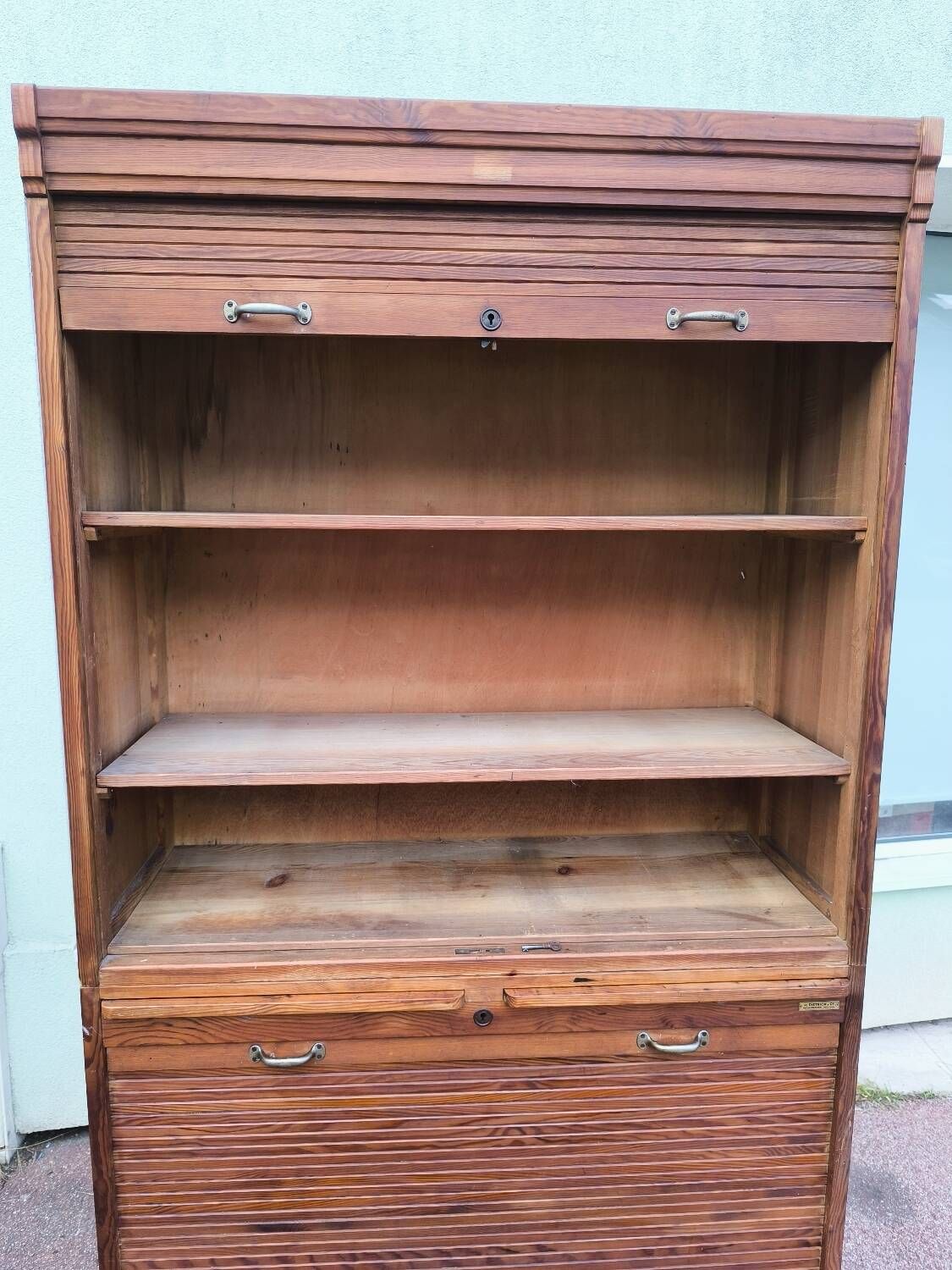 Vintage 1940s secretary desk with wooden curtains, storage, and shutters.