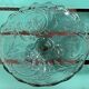 Footed bowl or pressed glass compote with floral decoration for table decor.