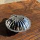 Vintage silver-plated shell butter dish with transparent bowl.