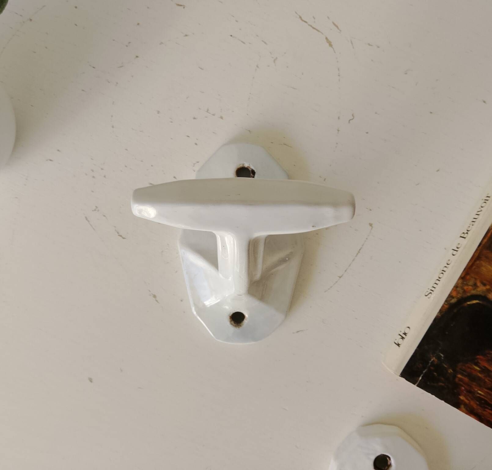 Antique Art Deco wall coat hook in enamelled cast iron.