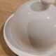 White porcelain butter dish accompanied by its matching bell.
