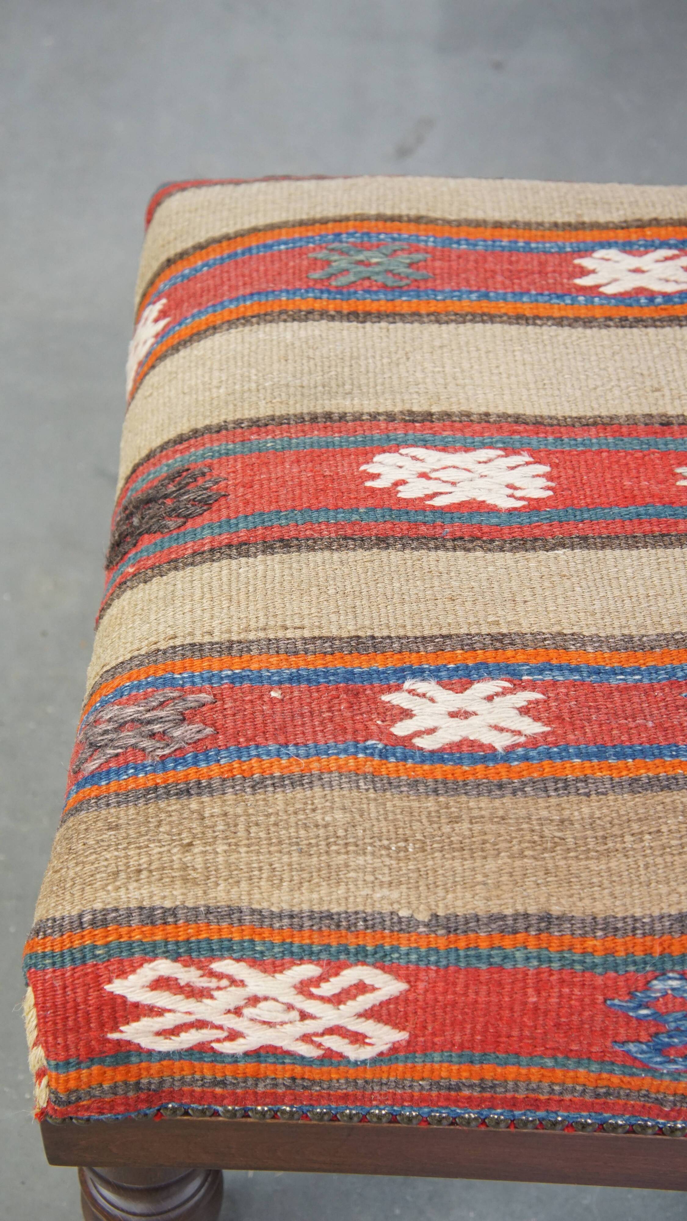 Oriental pouf upholstered in an antique kilim