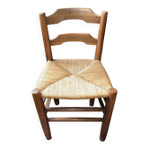 Old rustic wooden armchair – seat in woven rush