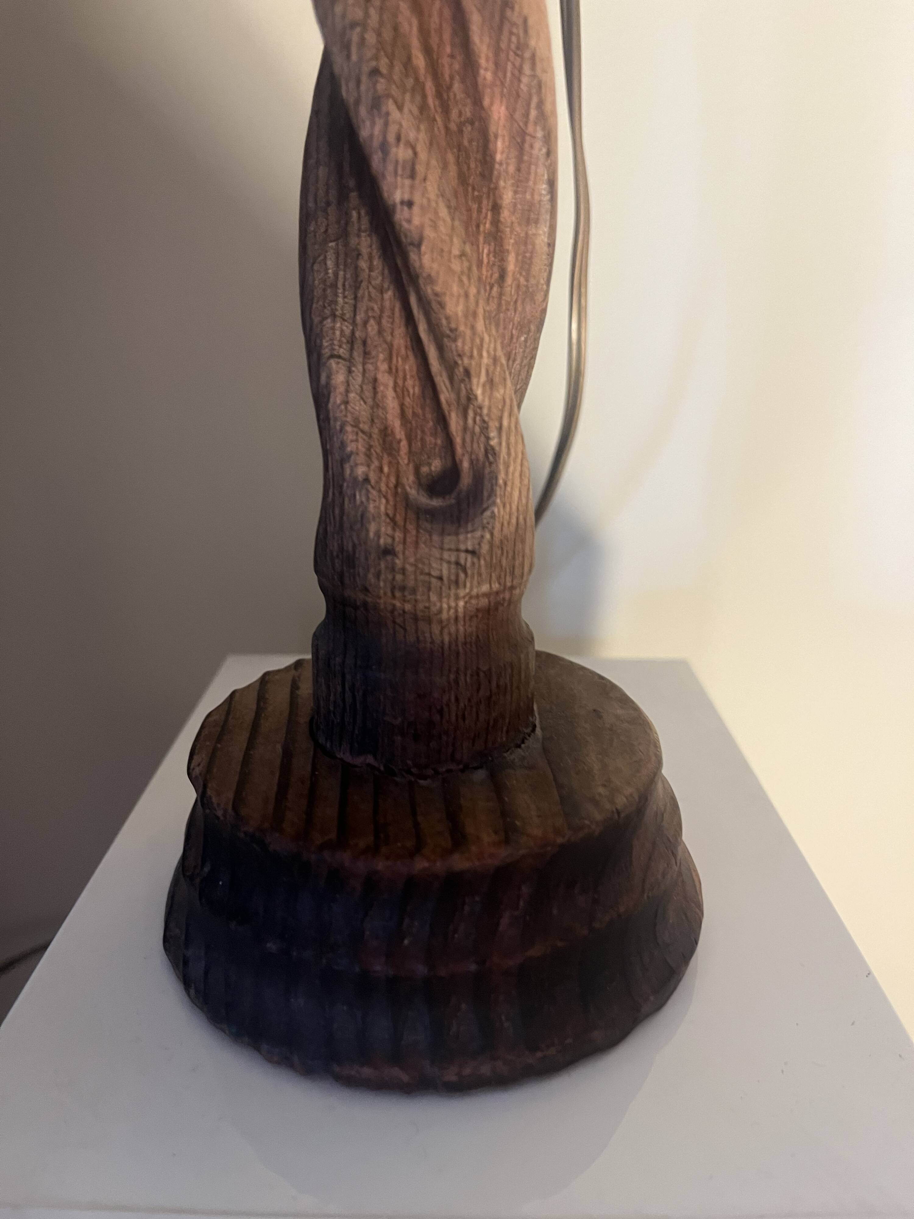 Wooden floor lamp with white tweed shade.
