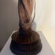 Wooden floor lamp with white tweed shade.