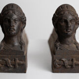 Pair of ancient cast iron chenets adorned with bust of Marianne