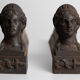 Pair of ancient cast iron chenets adorned with bust of Marianne