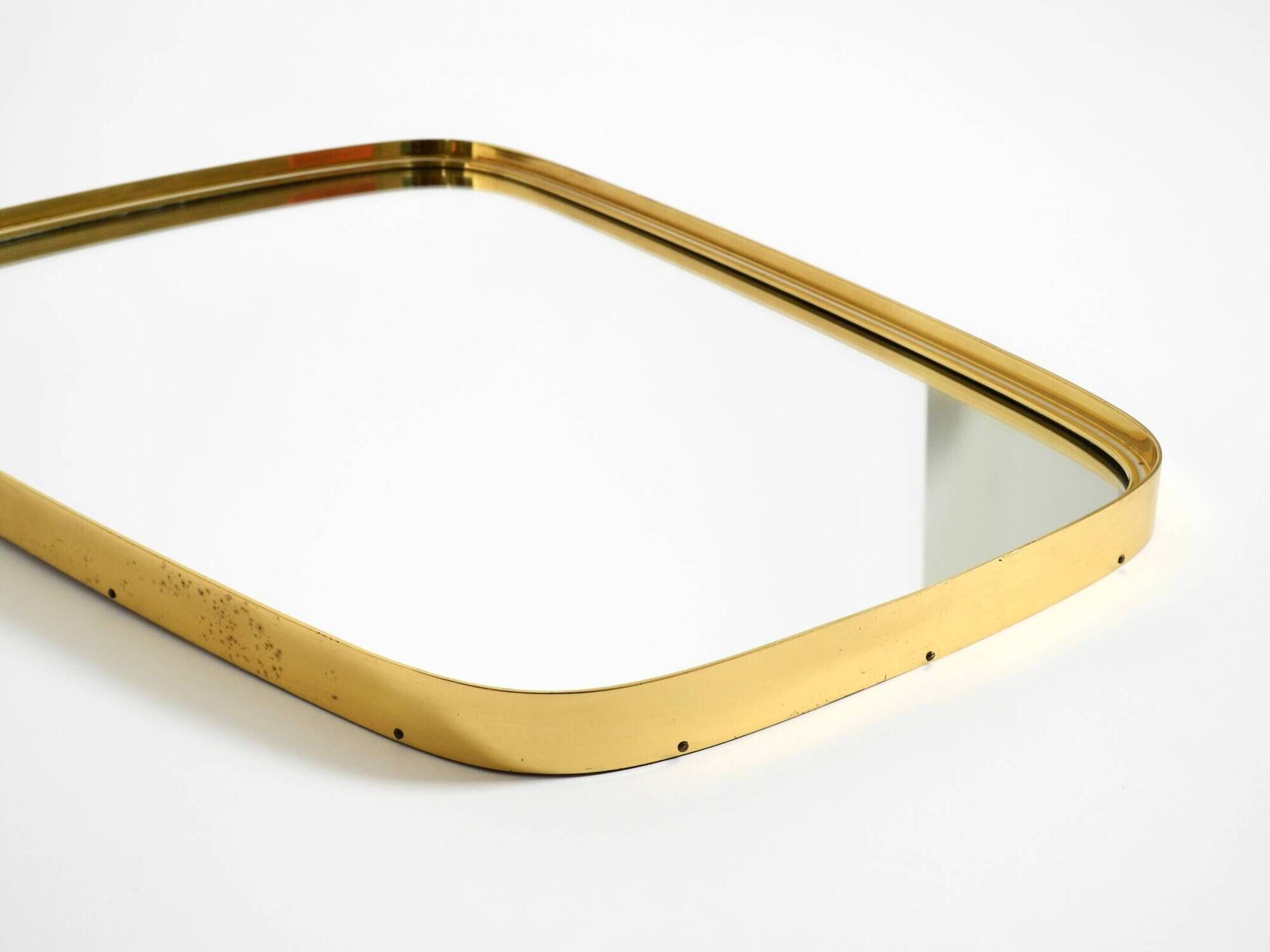 A pair of rare Mid Century "Münchener Zierspiegel" brass wall mirrors