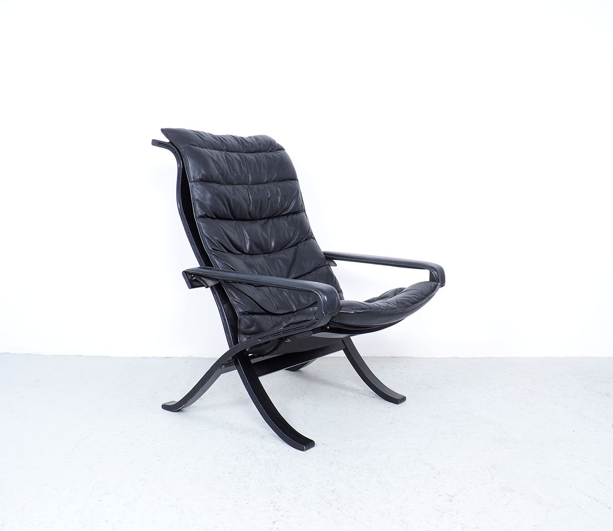 Westnofa black leather Flex armchair with ottoman