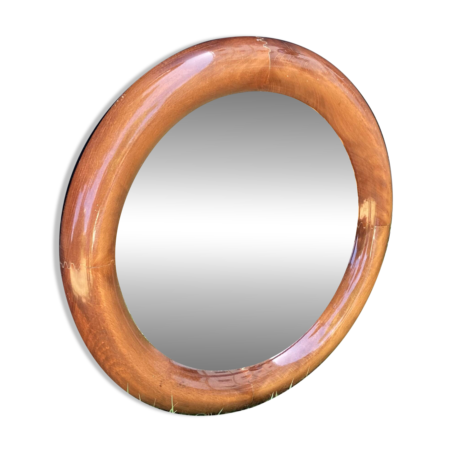 Round varnished wooden mirror