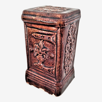 Piggy bank in the shape of a glazed safe decorated in brown color