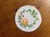 White napkin embroidered with vintage-coloured thread.