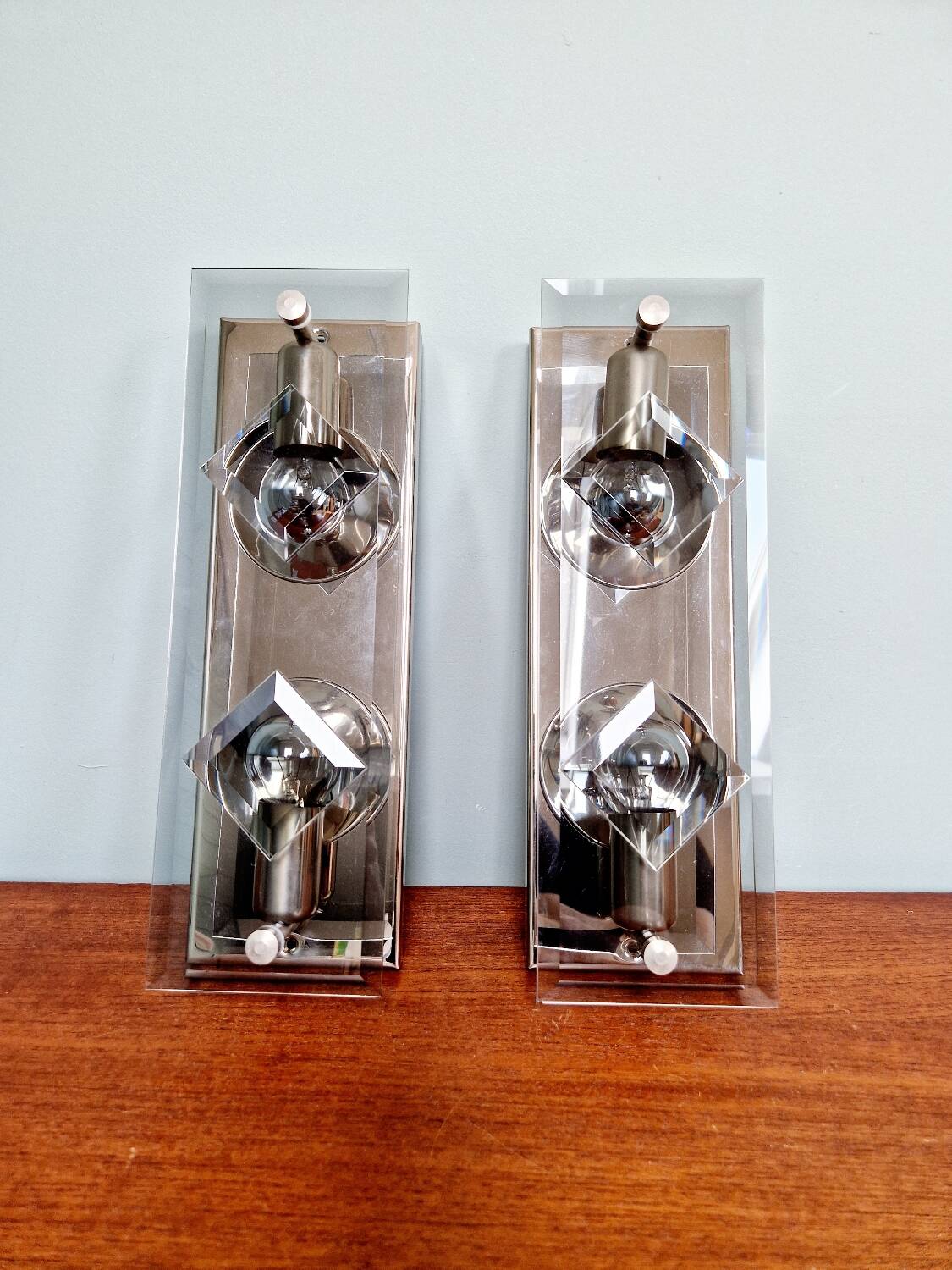 Pair of chrome metal and smoked glass wall sconces, 1970s.