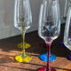 Champagne coupes in glass, multicoloured stems.