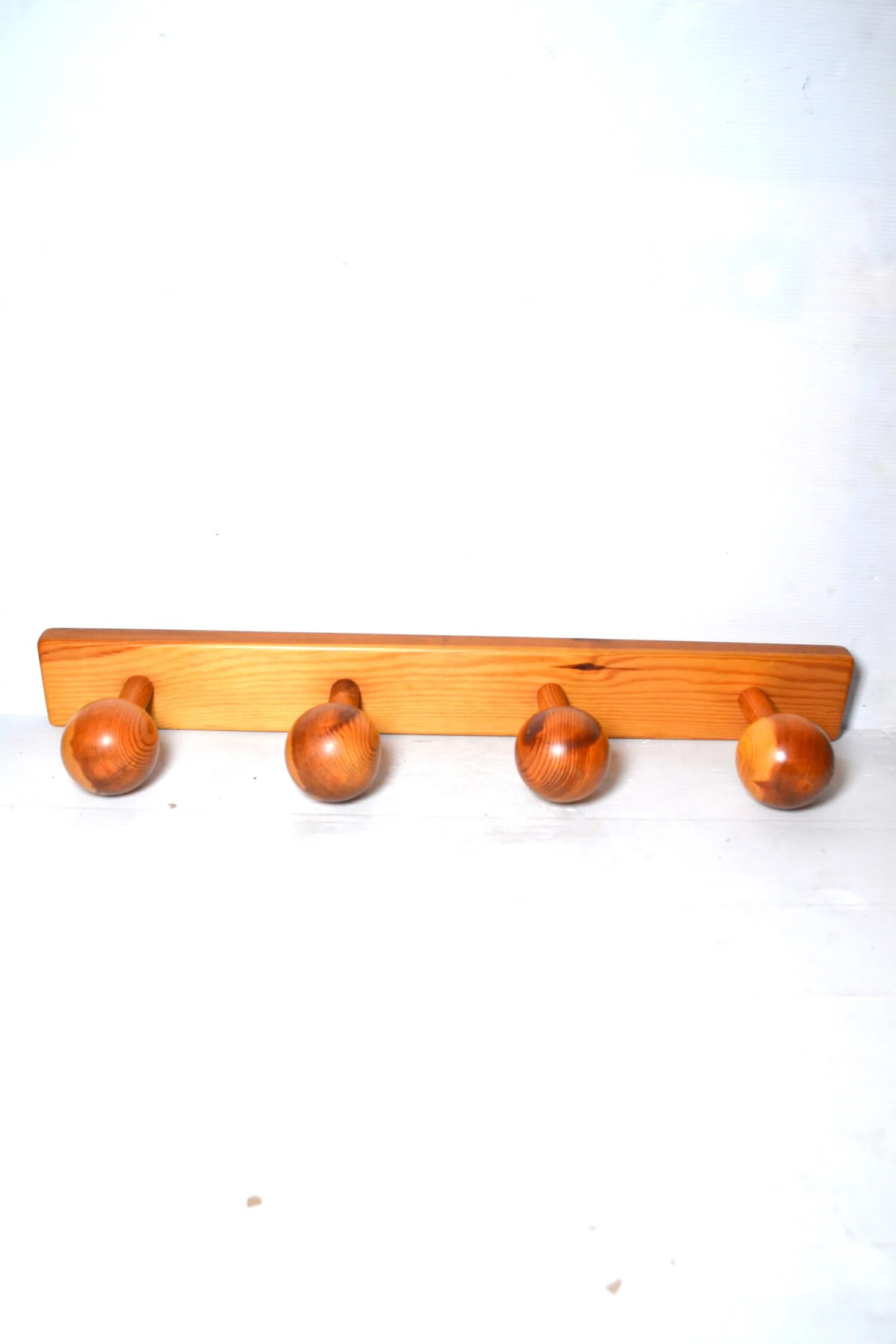 Vintage wall-mounted coat rack in solid pine.