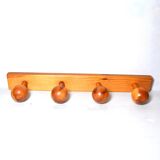 Vintage wall-mounted coat rack in solid pine.