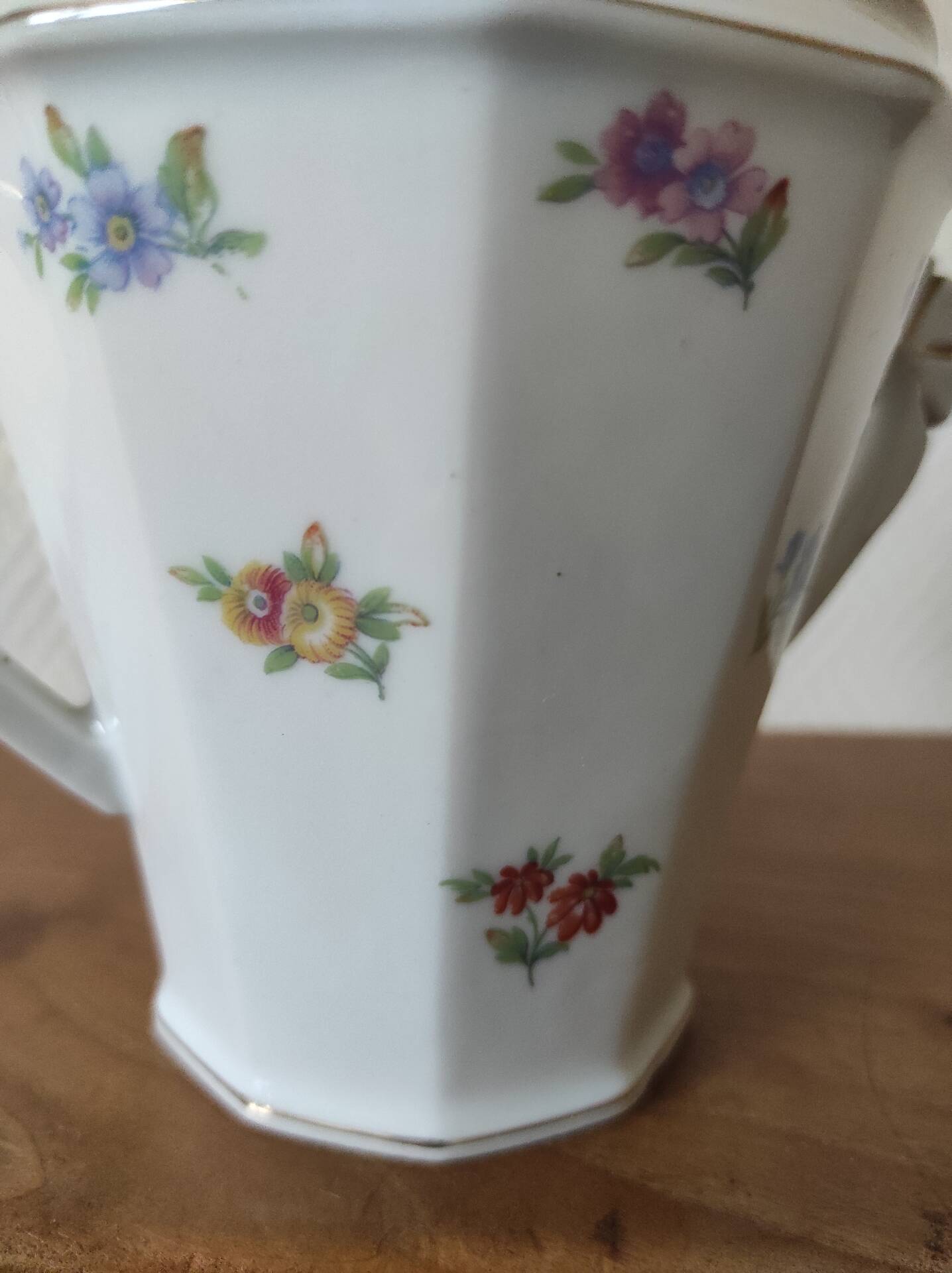 Antique porcelain sugar bowl with a decagonal base.