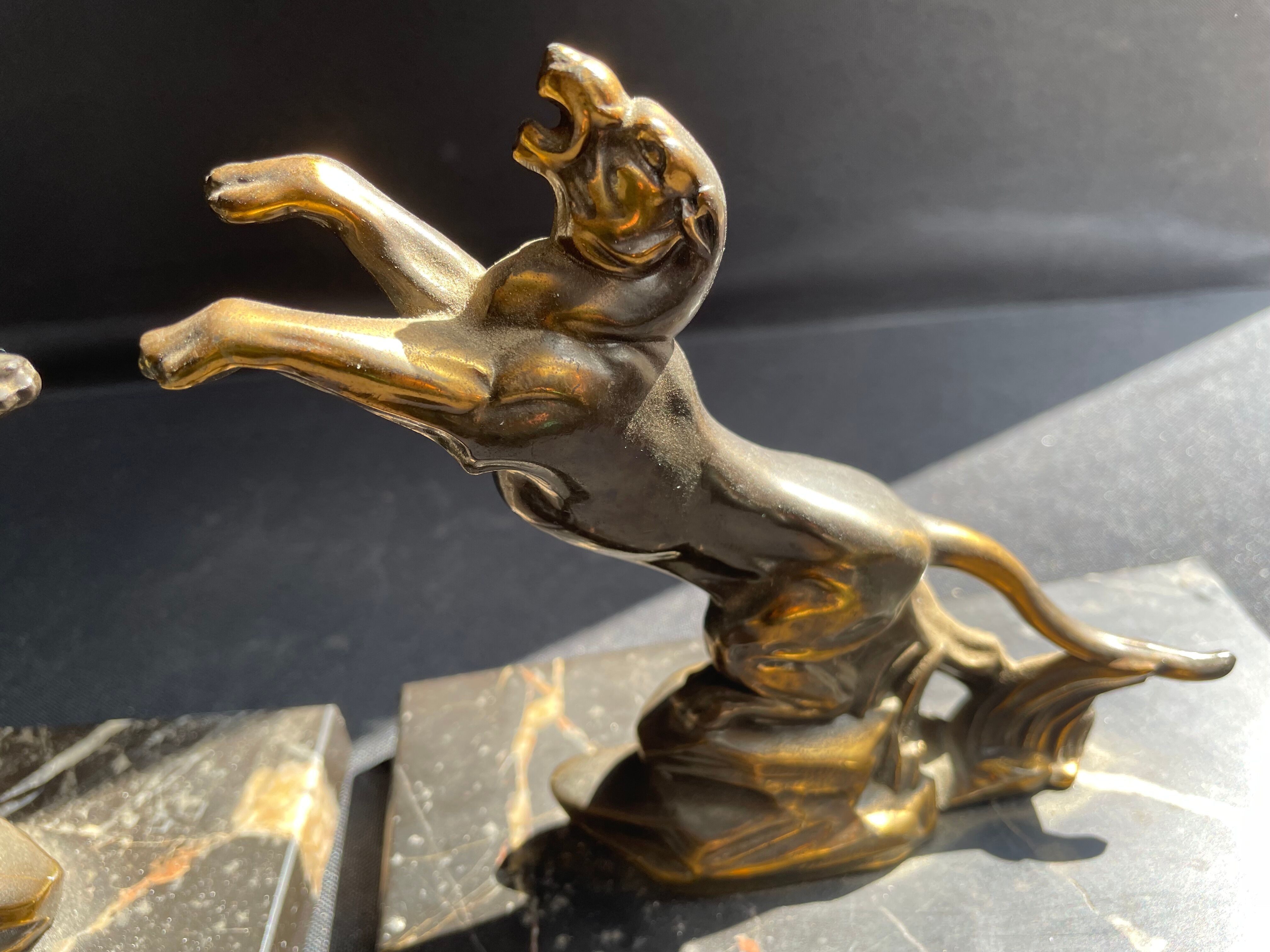 Pair of art deco marble and patinated regulated bookends