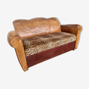 Old art deco club sofa in leather and leopard pattern