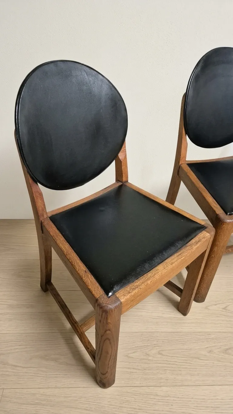 Set of four vintage wooden dining chairs with black leather upholstery, 85 × 45 × 45 cm