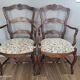 Pair of Provençal armchairs in brown wood and floral fabric.