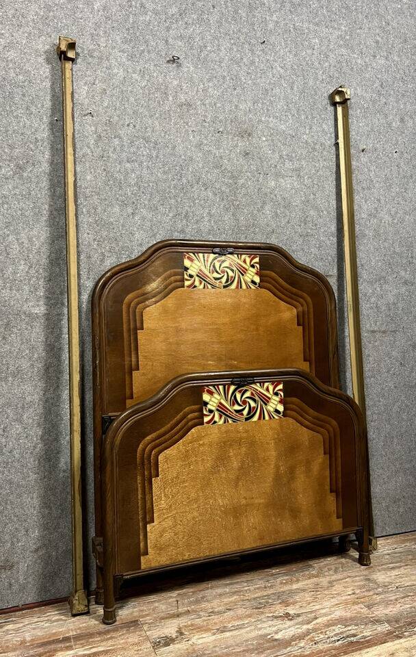 Art Nouveau period bed in painted iron faux wood with stylized colored patterns