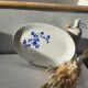 Keller and Guérin Lunéville serving dish with blue flowers on a white background.