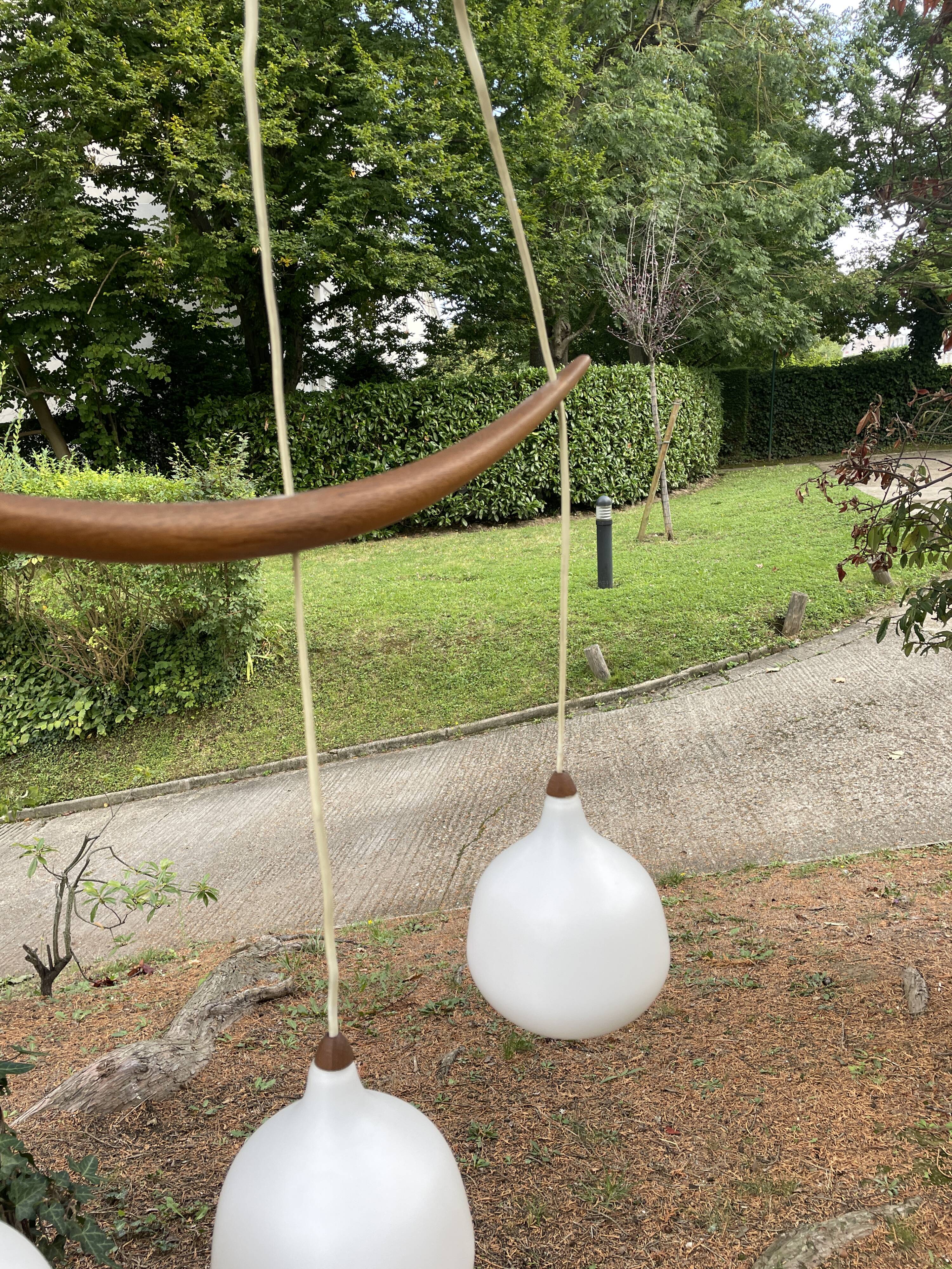 Scandinavian triple pendant light in Opaline and oak by Uno & Östen Kristiansson.
