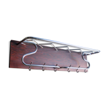 Chrome metal patere in a wooden support panel coat veneer.