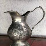 Tin pitcher decorating bunch of grapes