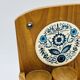 Wall-mounted egg cup holder and wooden utensil holder.