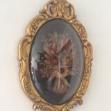Golden wood frame and vintage bulging glass